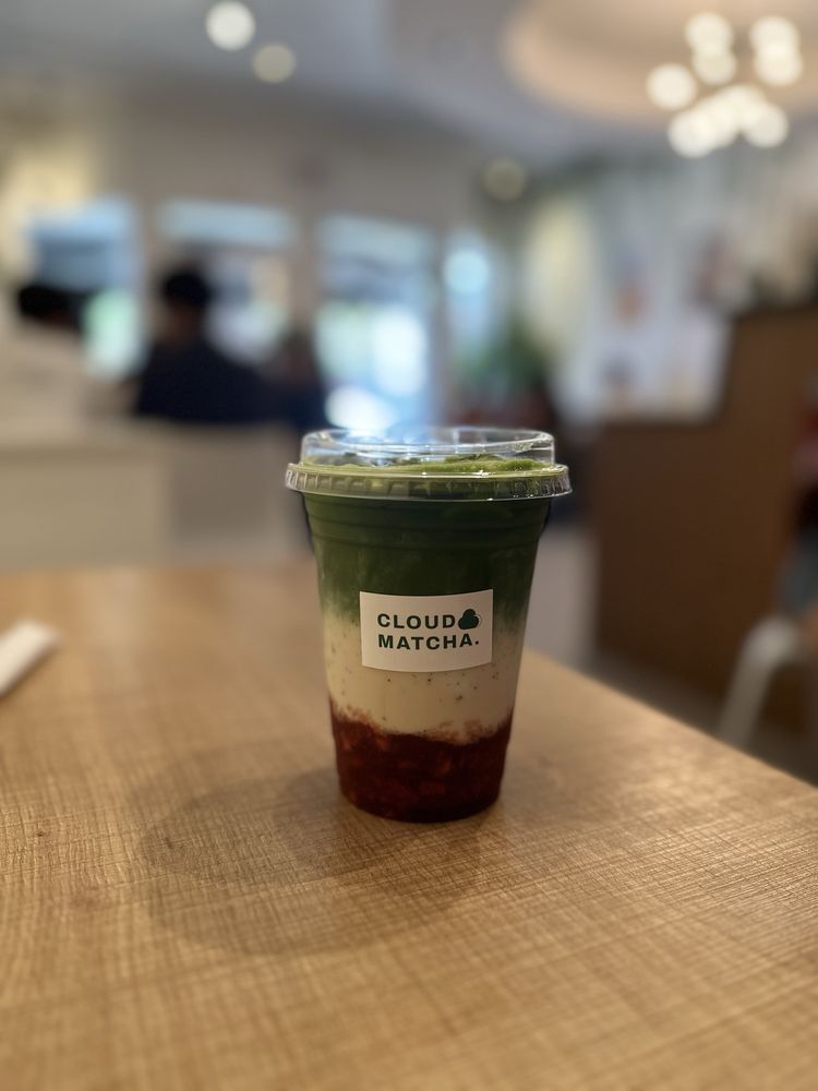 Cloud Matcha layered latte in a branded cup